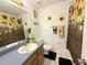 Bright bathroom featuring a sunflower-themed shower curtain and decor at 4586 Cr 696, Webster, FL 33597