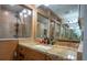 Vanity with double mirrors, a sink, and a granite countertop at 4586 Cr 696, Webster, FL 33597