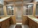 Bathroom featuring a step-in shower between two vanities with granite counters at 4586 Cr 696, Webster, FL 33597