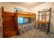 Comfortable bedroom features a wooden bunk bed and matching antique style vanity at 4586 Cr 696, Webster, FL 33597