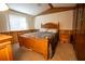 Bedroom with wood paneled walls, neutral carpet, and wooden bed frame at 4586 Cr 696, Webster, FL 33597
