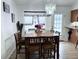 Cozy dining area with chandelier, wood table, and seating for six at 4586 Cr 696, Webster, FL 33597
