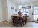 Inviting dining area features a chandelier, table for six, and natural light at 4586 Cr 696, Webster, FL 33597