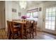 Bright dining area with a wooden table, chairs, chandelier, and access to the backyard at 4586 Cr 696, Webster, FL 33597