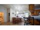 A dining area featuring a wooden table, chairs, chandelier, and access to the kitchen at 4586 Cr 696, Webster, FL 33597