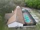 Aerial view of backyard, pool, and a well-maintained roof with trees surrounding property at 4586 Cr 696, Webster, FL 33597
