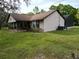 A single-Gathering home featuring a covered porch, well-maintained lawn, and a conventional roof at 4586 Cr 696, Webster, FL 33597