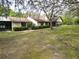 Exterior shot of the side and front of the house with a large yard at 4586 Cr 696, Webster, FL 33597