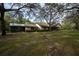 Charming house with mature trees in the front yard and screened in porch at 4586 Cr 696, Webster, FL 33597