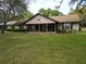 Exterior elevation of a single-story home with a large front yard at 4586 Cr 696, Webster, FL 33597