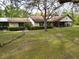 Front view of home with a covered porch and large lawn at 4586 Cr 696, Webster, FL 33597