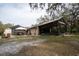 View of exterior with screened-in patio, gazebo, and lush surroundings at 4586 Cr 696, Webster, FL 33597