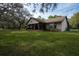 Exterior of a house with a green lawn and mature trees at 4586 Cr 696, Webster, FL 33597