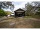Exterior of screened in porch from yard with mature trees at 4586 Cr 696, Webster, FL 33597