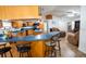 An open concept kitchen with an island and barstool seating that overlooks the living room at 4586 Cr 696, Webster, FL 33597