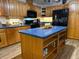 Well-lit kitchen boasts an island with storage, updated appliances, and wood cabinets at 4586 Cr 696, Webster, FL 33597