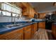 Traditional kitchen with wood cabinets, a double sink, and modern appliances at 4586 Cr 696, Webster, FL 33597