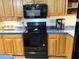 This kitchen showcases wood cabinets, black appliances, and light blue countertops at 4586 Cr 696, Webster, FL 33597