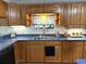 The kitchen features wood cabinets, a double basin sink, and light blue countertops at 4586 Cr 696, Webster, FL 33597