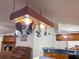 A well-lit kitchen features wooden cabinets and a pot rack hanging above the center island at 4586 Cr 696, Webster, FL 33597