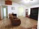Spacious living room with hardwood floors, neutral walls, and comfortable recliner seating at 4586 Cr 696, Webster, FL 33597
