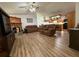 Comfortable living room featuring hardwood floors, fireplace and open concept to the kitchen at 4586 Cr 696, Webster, FL 33597