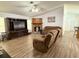 Comfortable living room featuring hardwood floors, fireplace, and a large entertainment center at 4586 Cr 696, Webster, FL 33597