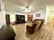 Spacious living room featuring a stone fireplace, vaulted ceilings, and wood-look flooring at 4586 Cr 696, Webster, FL 33597
