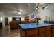 An open-concept layout with a kitchen island and a living room featuring a stone fireplace at 4586 Cr 696, Webster, FL 33597