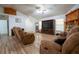 An open living room with wood-look floors, a stone fireplace, and comfortable seating at 4586 Cr 696, Webster, FL 33597