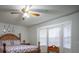 Bright bedroom with a large window, ceiling fan, and a wood bed at 4586 Cr 696, Webster, FL 33597