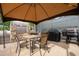 Outdoor kitchen area with grill, table and seating under a gazebo at 4586 Cr 696, Webster, FL 33597