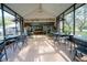 Covered patio with seating area looks toward a distant game room and backyard at 4586 Cr 696, Webster, FL 33597