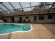 View of the house from the screened in pool area with lounging area and jacuzzi at 4586 Cr 696, Webster, FL 33597