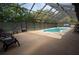Large, enclosed pool with lounge chairs and ample deck space at 4586 Cr 696, Webster, FL 33597
