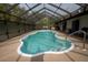 Screened-in pool area featuring a kidney-shaped pool and deck at 4586 Cr 696, Webster, FL 33597