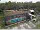 Aerial view of the screened-in pool and the outdoor patio area with a built-in stone fireplace at 4586 Cr 696, Webster, FL 33597