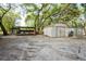 View of two metal storage sheds and covered area on grassy lot at 4586 Cr 696, Webster, FL 33597