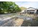 Large yard and back of house with covered patio with seating area at 4586 Cr 696, Webster, FL 33597