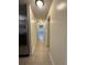 Hallway with tile floors connects the kitchen and living areas with plenty of natural light at 5835 Talavera St, Orlando, FL 32807