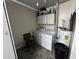 Functional laundry room with washer, dryer, storage cabinets, and neutral finishes at 5835 Talavera St, Orlando, FL 32807