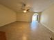 Spacious living room features neutral walls, tile floors, ceiling fan, and sliding door access to the yard at 5835 Talavera St, Orlando, FL 32807