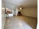 Expansive open-concept living area with tile flooring, ceiling fan, and views into the kitchen at 5835 Talavera St, Orlando, FL 32807