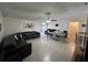 Spacious living room featuring tile floors, dark sofas, dining table, ceiling fan and large light-filled windows at 5835 Talavera St, Orlando, FL 32807