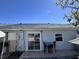 Back patio with sliding glass door and small outdoor table set at 5835 Talavera St, Orlando, FL 32807