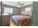 Comfortable bedroom featuring a large bed, hardwood floors and natural light at 1043 Pineview Pl, Lakeland, FL 33801