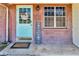 Close up of the front door featuring a blue door and brick surround at 1043 Pineview Pl, Lakeland, FL 33801