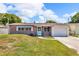 Charming brick home with a well-maintained lawn, blue door, and attached one-car garage at 1043 Pineview Pl, Lakeland, FL 33801