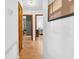 Hallway with wood floors leading to bedrooms, showcasing the home's layout at 1043 Pineview Pl, Lakeland, FL 33801