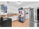 Bright kitchen featuring white cabinets, white appliances, and wood-look flooring at 1043 Pineview Pl, Lakeland, FL 33801